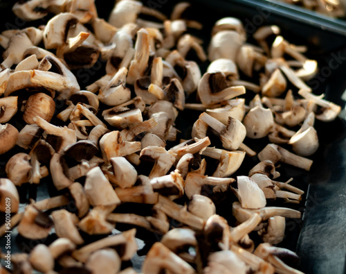 a tray with washed, dried and chopped mushrooms is being prepared for baking