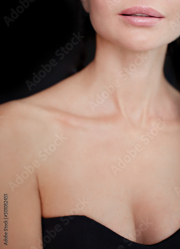 Obraz na płótnie Beauty women lips nude makeup, beautiful neck and neckline, clean skin on black