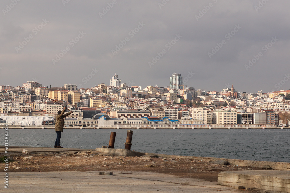 Man fishing on the shore of the Bosphorus in istanbul