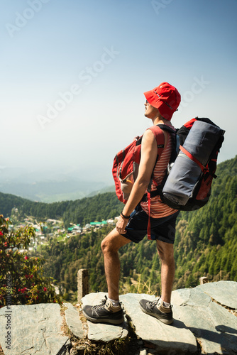 A Traveller Admiring the view at Triund, Indrahar Pass Trail, Dauladhar Range, Himachal Pradesh, India. photo