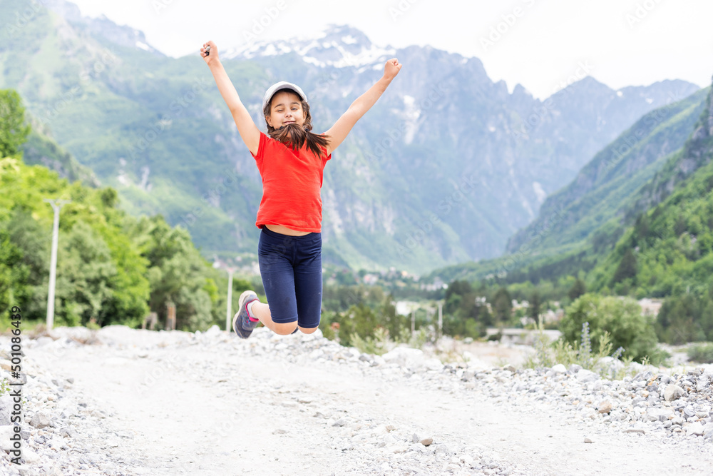 portrait of a girl against the panorama of the Alps