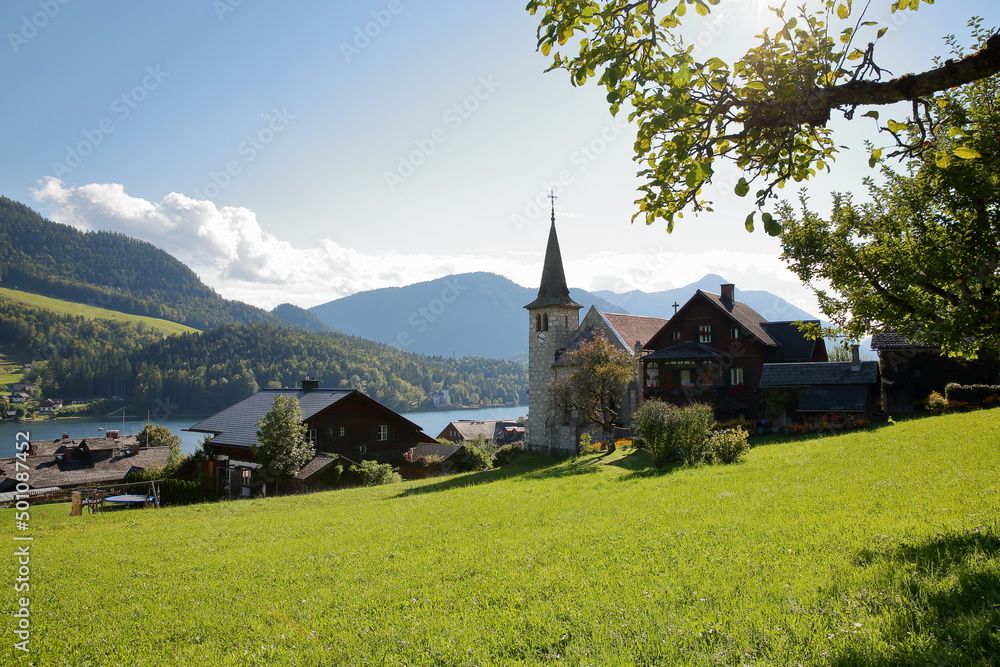 Grundlsee village overlooking Grundlsee lake (Western part) with the Catholic church (Pfarrkirche Herz Jesu) in the foreground, Salzkammergut, Styria, Austria, Europe