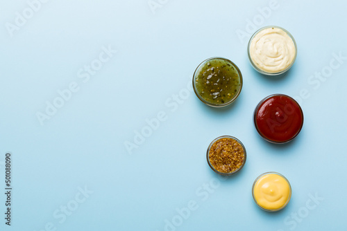 Billede på lærred Different types of sauces in bowls on a colored Board