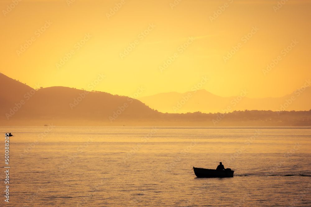 Sunrise at Foro Italico Coast of Palermo on Sicily in Europa, Italy in late spring April on a warm sunny orange day