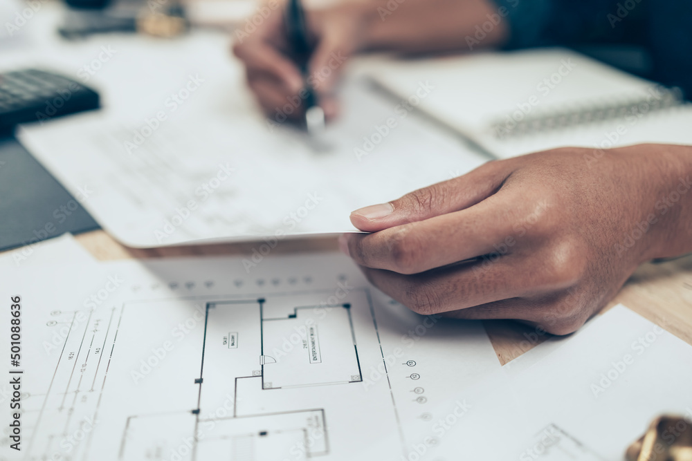 Architect engineer use pen drawing design working on blueprint. House planning design and construction concept. Architect engineer use pen drawing design working on blueprint. House planning design and construction concept.