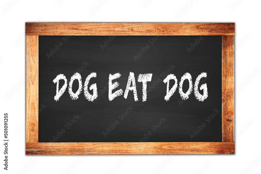 DOG EAT DOG text written on wooden frame school blackboard. DOG EAT DOG text written on wooden frame school blackboard.
