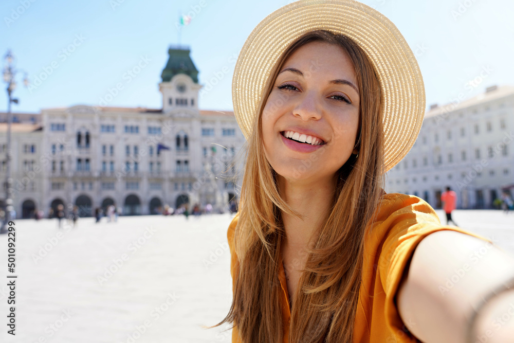 Cultural tourism in Italy. Self portrait of smiling traveler girl visiting Trieste, Italy.
