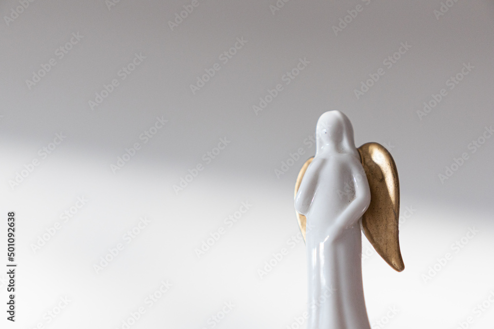Marble angel with golden wings Christmas figurine. Marble angel with golden wings Christmas figurine.