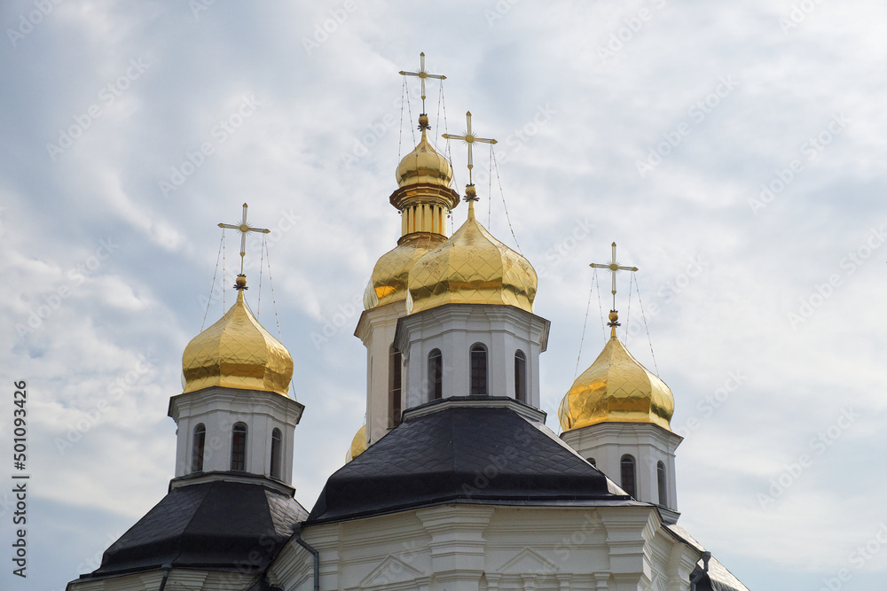 Gilded domes of an ancient Orthodox church against the sky. Catherine's Church is a functioning church in Chernihiv, Ukraine. St. Catherine's Church was built in the Ukrainian Baroque style.
