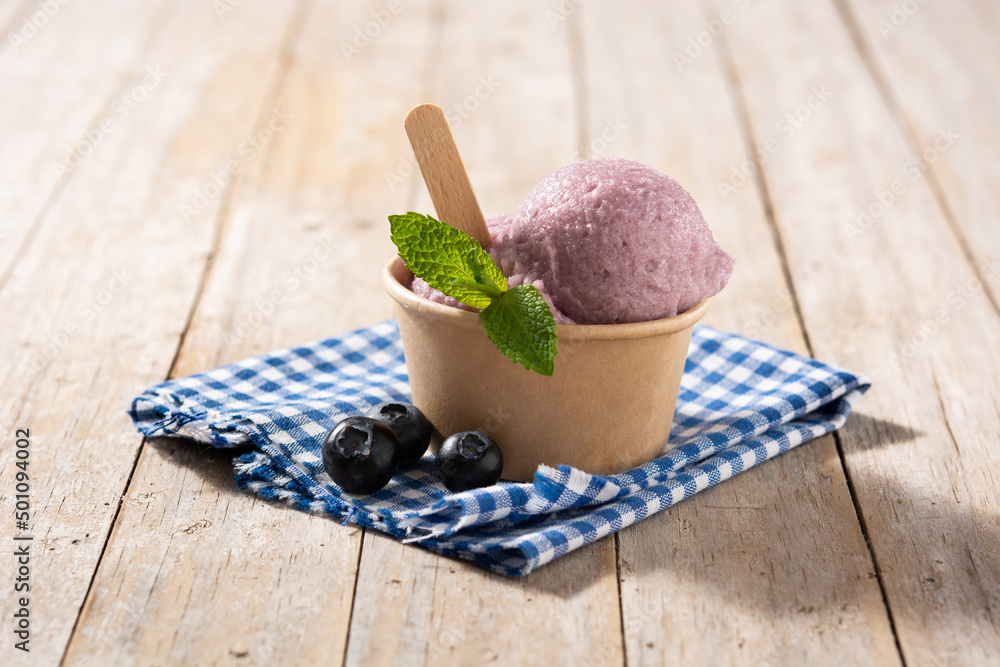 Blueberry ice cream scoop on wooden table Blueberry ice cream scoop on wooden table