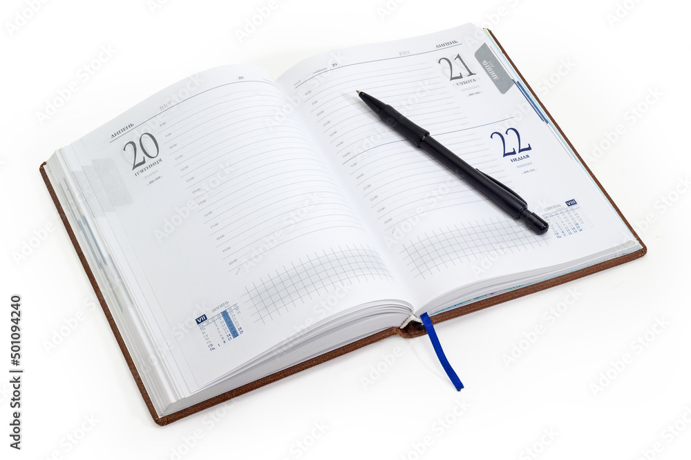 Open business diary in Ukrainian and English and black pen Open business diary in Ukrainian and English and black pen