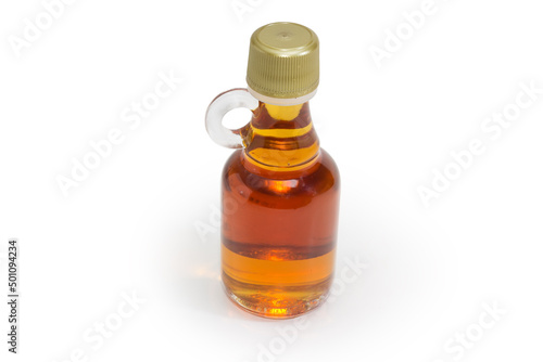 Bottled maple syrup on a white background