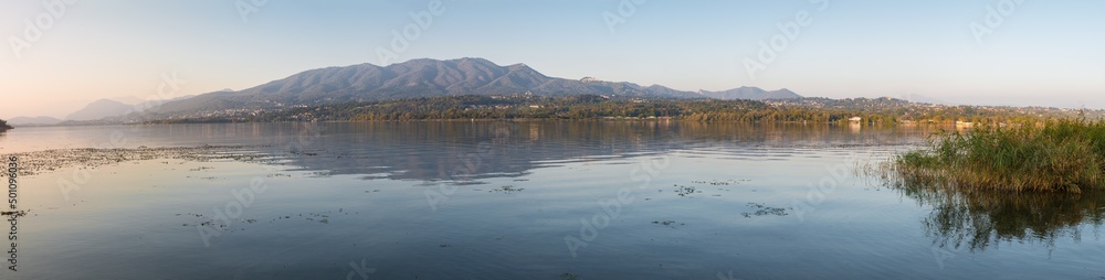 Lake at sunset, north Italy. Lake Varese (lago di Varese) with in the background the Campo dei Fiori massif. Famous because it hosts rowing competitions of national, european and world level