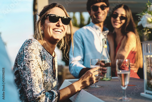 Canvas Print Happy friends gathering at terrace party having fun and drinking sparkling white