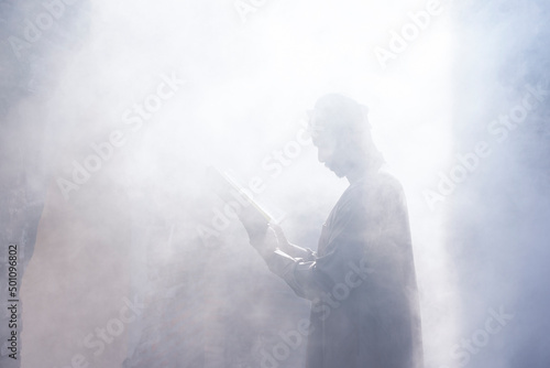 smoke Blur background muslim man having worship and praying for fasting and Eid of Islam culture in old mosque with lighting 
