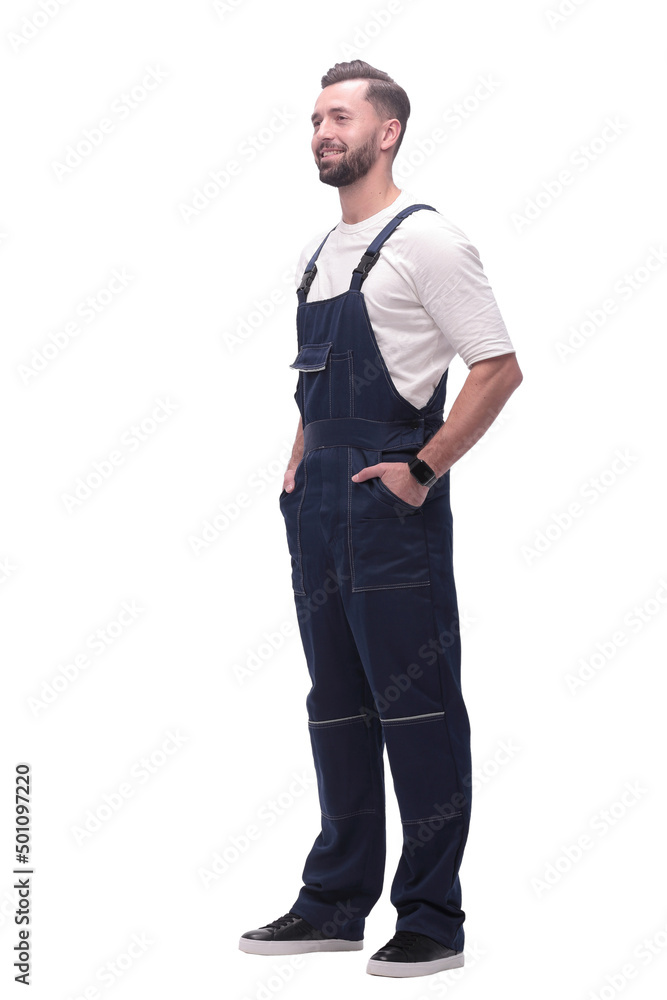 in full growth. smiling man in overalls. in full growth. smiling man in overalls.