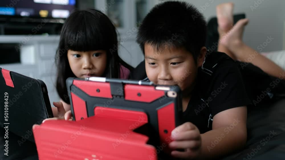two children addicted tablet, asian kid watching cartoon
two children addicted tablet, asian kid watching cartoon