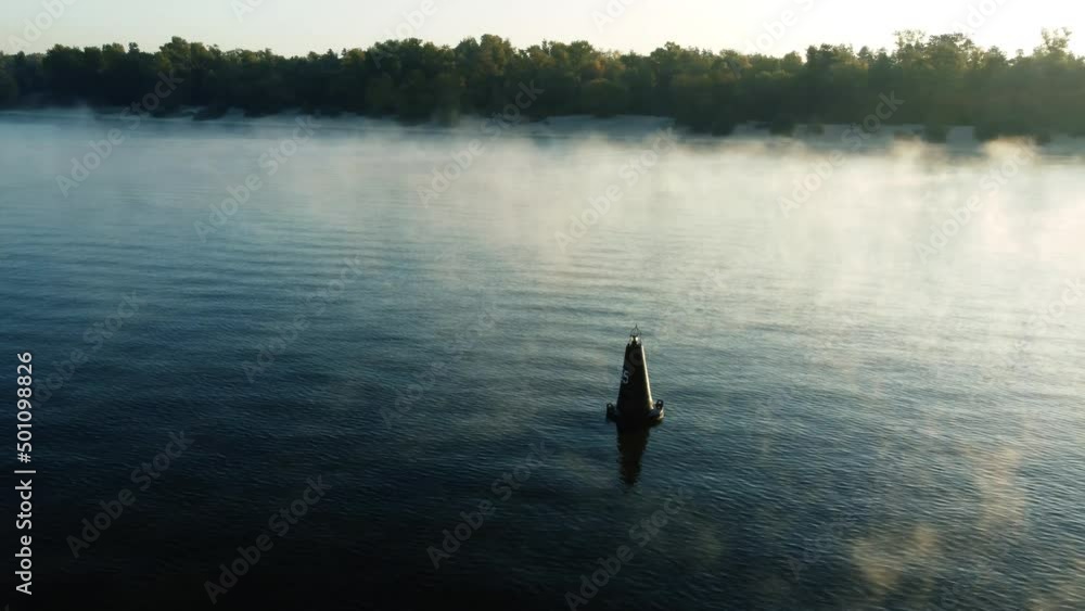 drone flies around a buoy on the river, morning mist over the water, fog drone flies around a buoy on the river, morning mist over the water, fog
