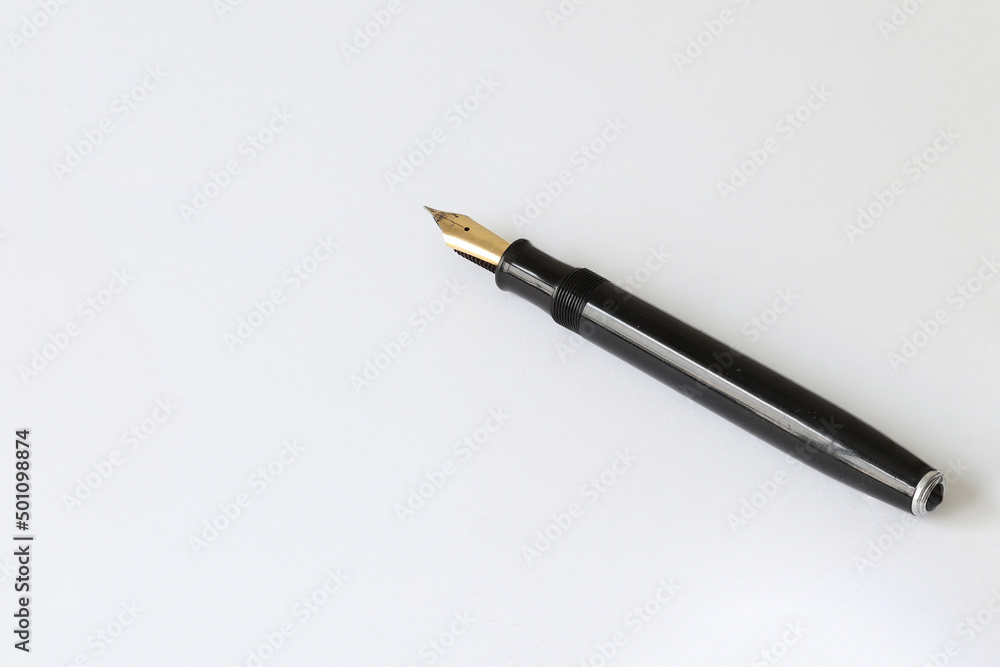 Old ink pen. Ink pen on a light sheet of paper. Old ink pen. Ink pen on a light sheet of paper.
