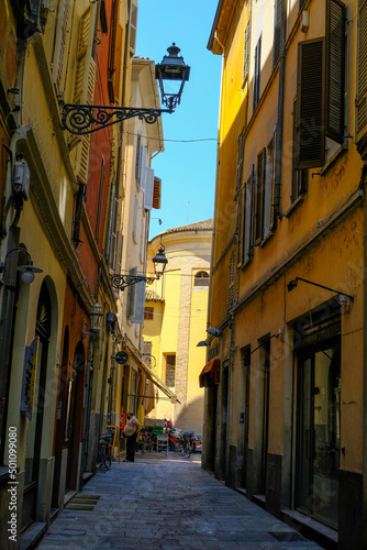 Parma, Italy: Old city streets on a sunny day and the cathedral in the back of the street. Travel destinations in Emilia-Romagna