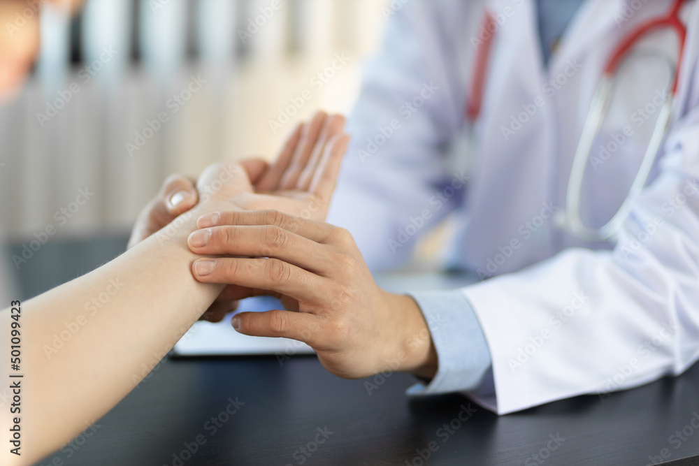 Health and medical examination concept. Doctor checking measuring pressure on patient's hand pulse by hands.