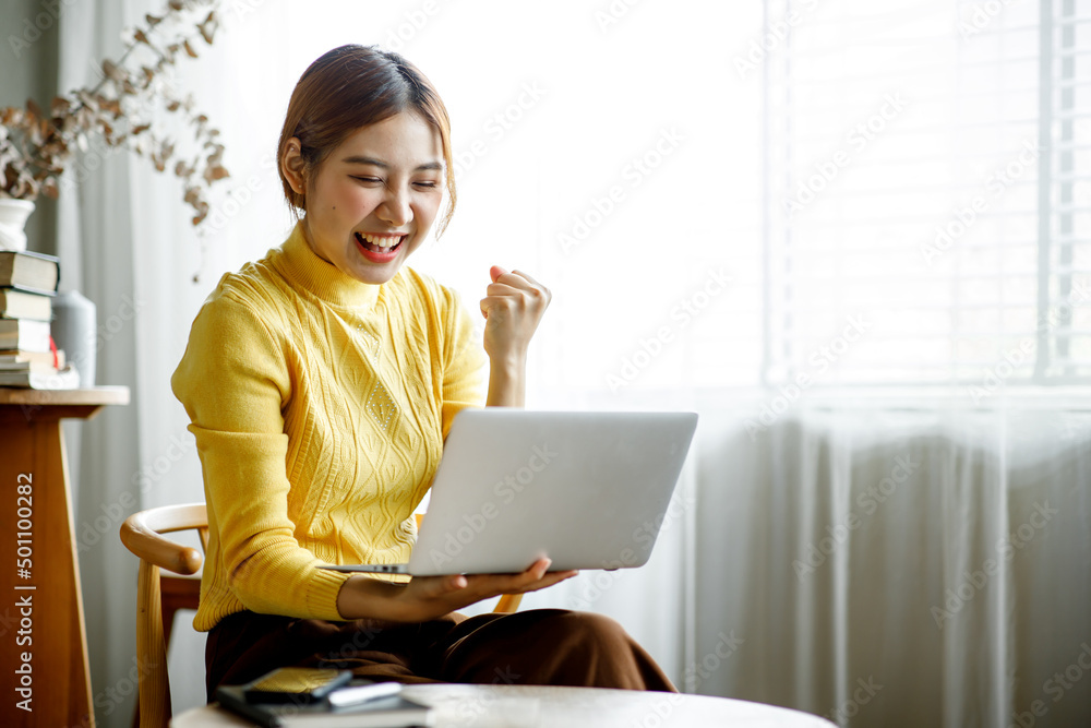 Happy Excited Asian woman looking at the laptop screen, celebrating an online win, overjoyed young Asian girl screaming with joy, isolated over a white blur background Happy Excited Asian woman looking at the laptop screen, celebrating an online win, overjoyed young Asian girl screaming with joy, isolated over a white blur background