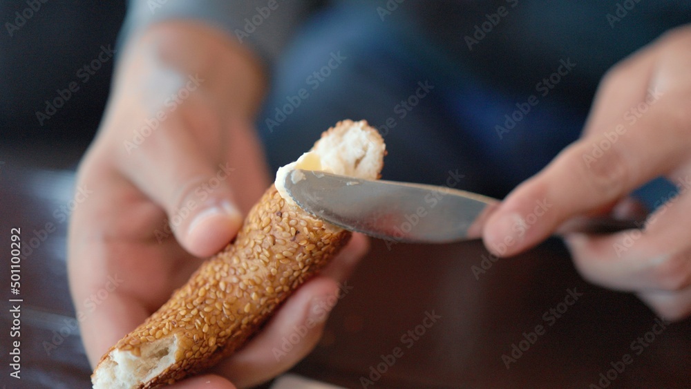Male hands spread butter on a piece of bread. Breakfast time Male hands spread butter on a piece of bread. Breakfast time