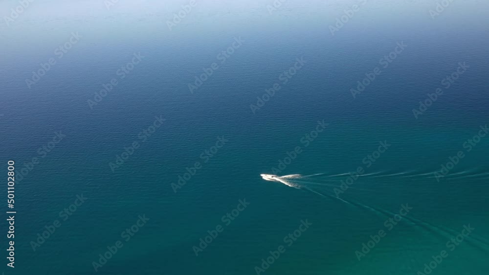 Aerial View Of Speedboat Cruising In The Calm Blue Waters. Aerial View Of Speedboat Cruising In The Calm Blue Waters.