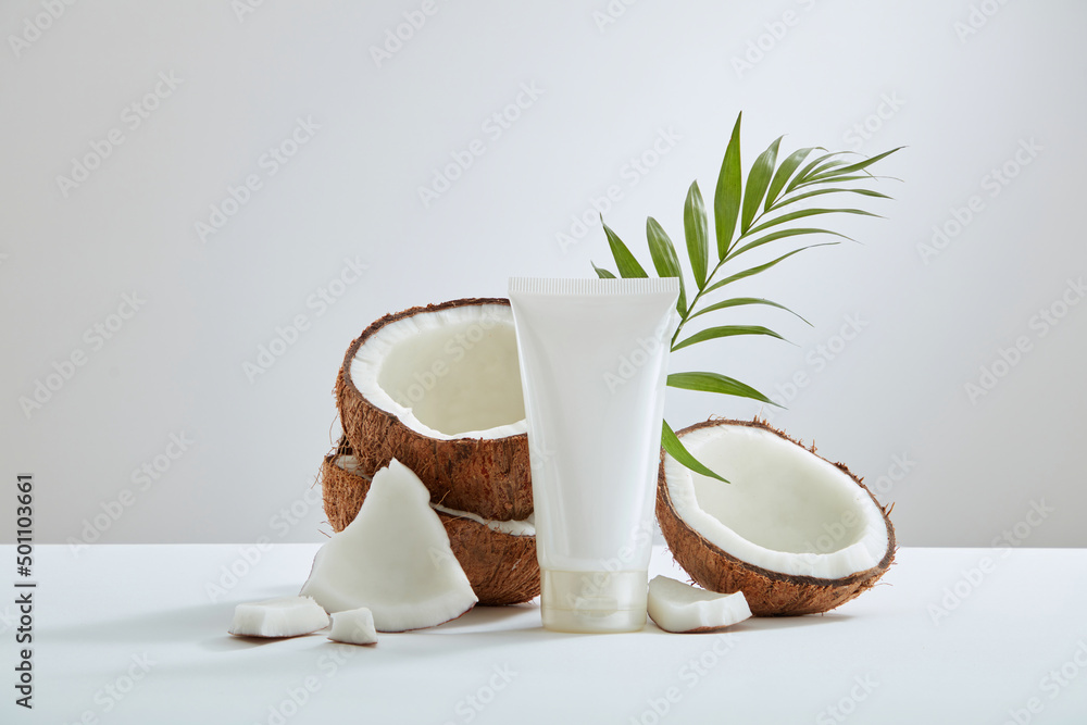 Top view of coconut and cosmetic decorated in pink background Top view of coconut and cosmetic decorated in pink background