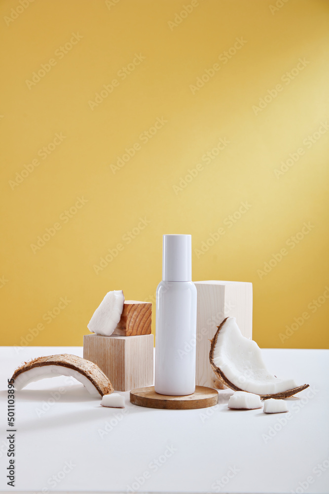 Top view of coconut and cosmetic decorated in yellow background Top view of coconut and cosmetic decorated in yellow background