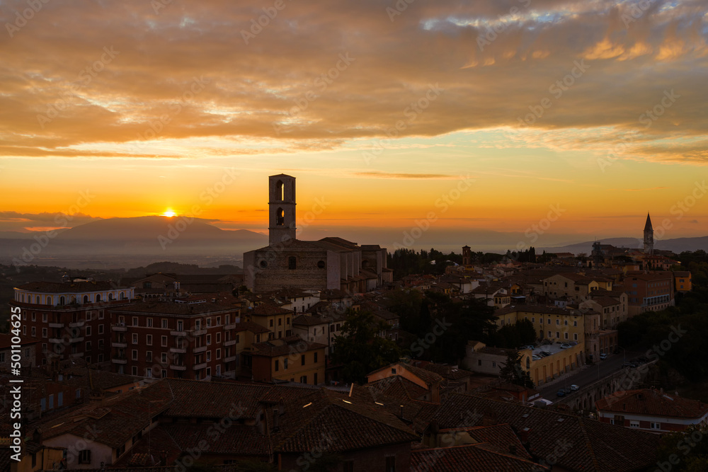 Beautiful dawn sky with morning haze over the old city of Perugia, with medieval bell towers and Umbria countryside in the background