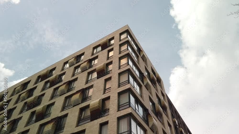 Exterior of a high-rise multi-story apartment building - facade, windows and balconies. Hyperlapce footage. Exterior of a high-rise multi-story apartment building - facade, windows and balconies. Hyperlapce footage.
