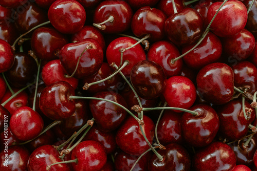 Background image of lying red ripe sweet cherries. Top view. Flat lay. Copy space