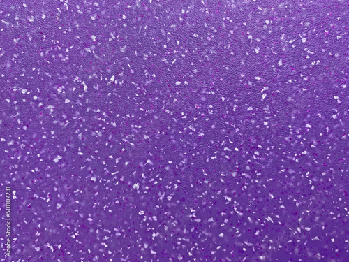 close up of purple plastic board with white spots