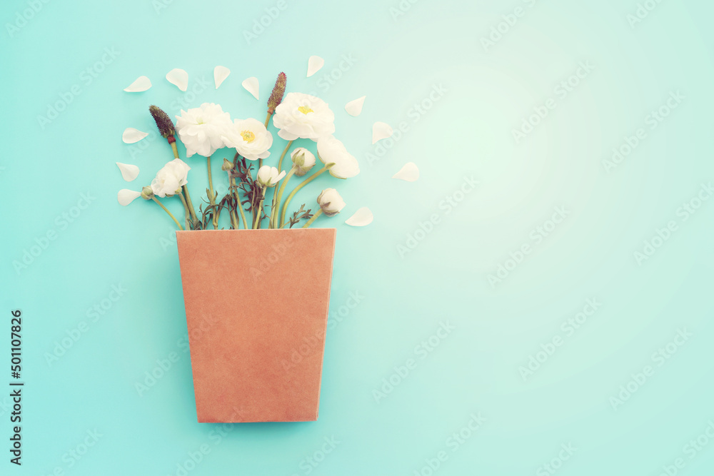 Top view image of white flowers composition over blue pastel background - obrazy, fototapety, plakaty 