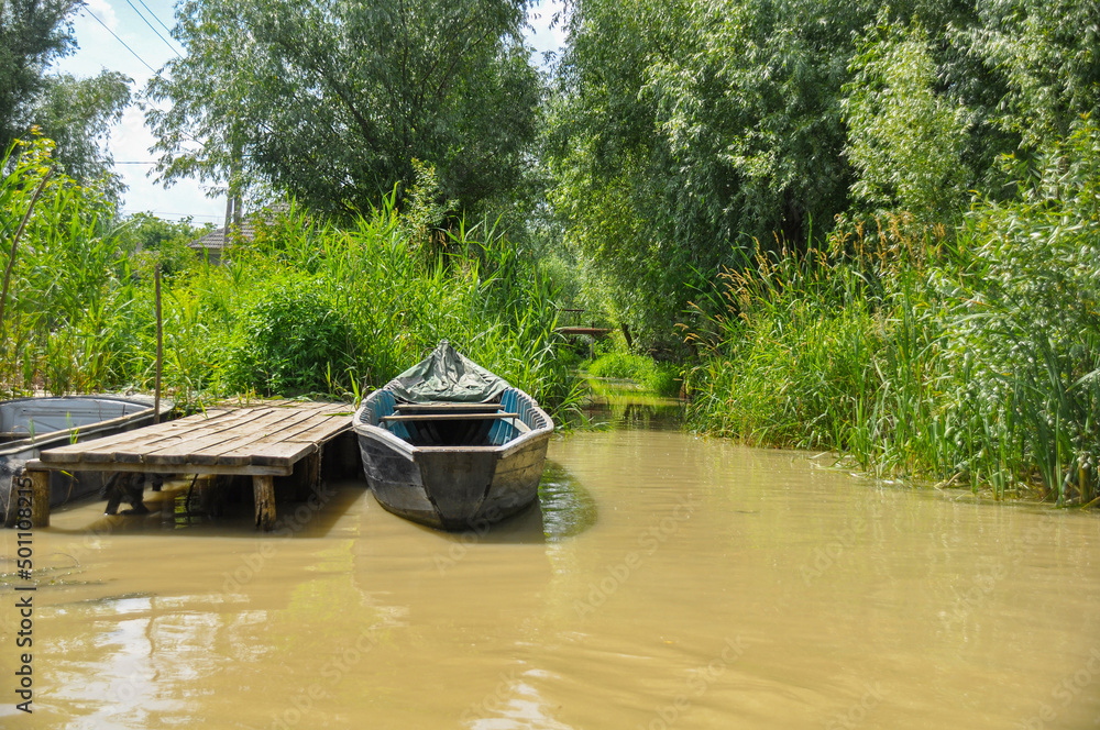 Ukraine city of Vilkovo. The Danube River flows along piers with boats and houses Ukraine city of Vilkovo. The Danube River flows along piers with boats and houses