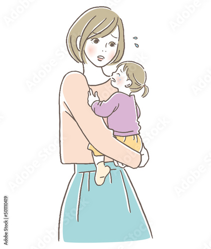 泣く子供を抱っこしている母親