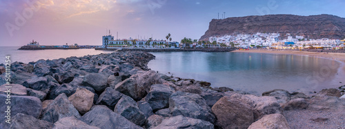 View of Puerto de Mogan beach and town at sunset, Playa de Puerto Rico, Gran Canaria, Canary Islands photo