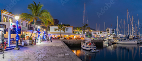 View of cafes and restaurants, Puerto de Mogan and mountainous background at dusk, Puerto de Mogan, Gran Canaria, Canary Islands