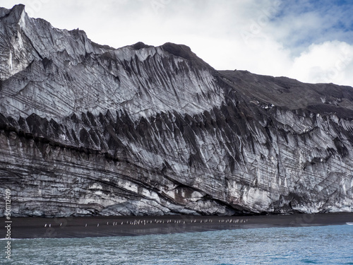 Penguins marching along a glacier face on Saunders Island, South Sandwich Islands photo