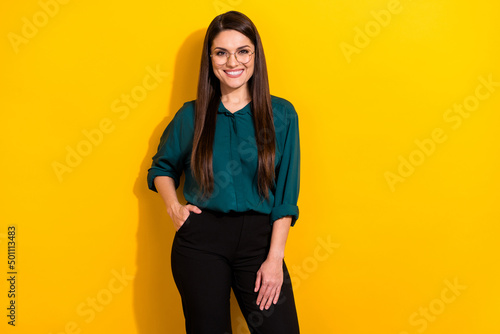 Photo of cute sweet woman wear green shirt spectacles empty space smiling isolated yellow color background © deagreez
