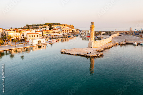 Aerial view of the calm sea at dawn surrounding the old Venetian port and lighthouse, Rethymno, Crete island, Greek Islands photo