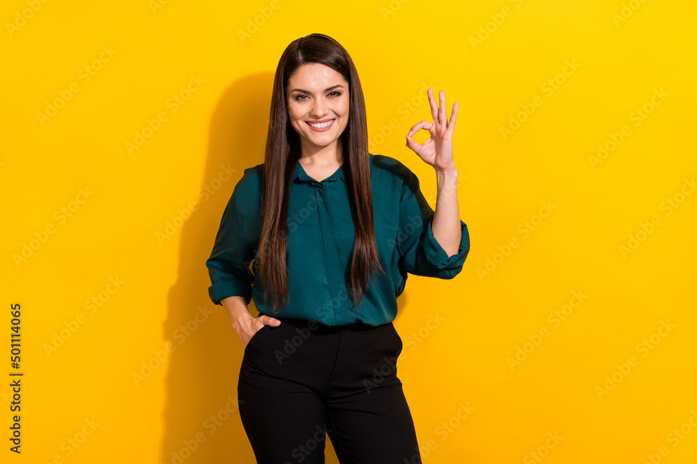 Photo of young pretty lady show fingers okey symbol approve good decision feedback isolated over yellow color background Photo of young pretty lady show fingers okey symbol approve good decision feedback isolated over yellow color background