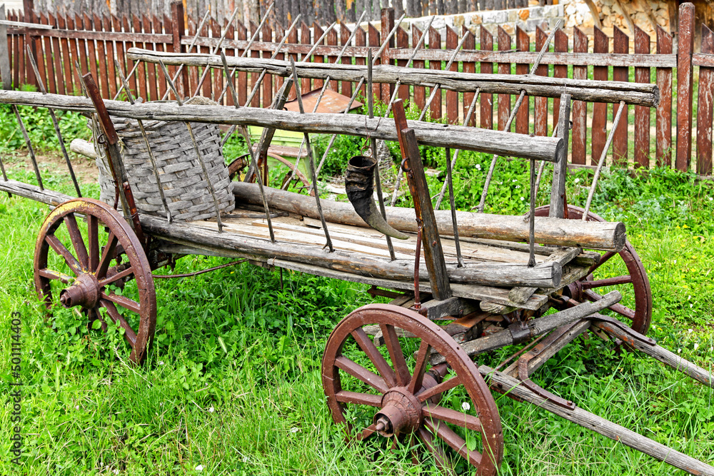 Fototapeta premium Old wooden cart parked in garden