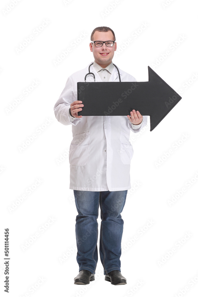 Front view of young smiling doctor holding a black arrow pointing right Front view of young smiling doctor holding a black arrow pointing right