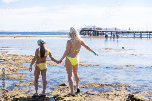 mother and daughter on the beach along dead coral sharm el sheikh © Angelov