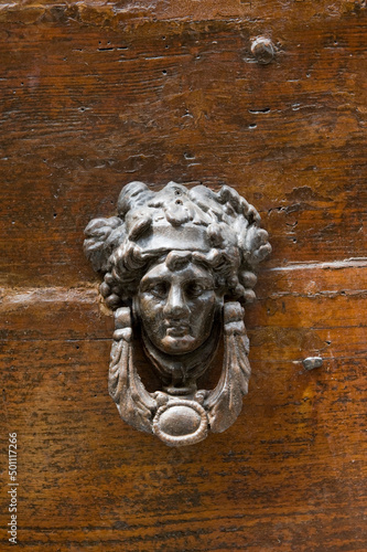 Türklopfer mit Gesicht auf einer Holztür