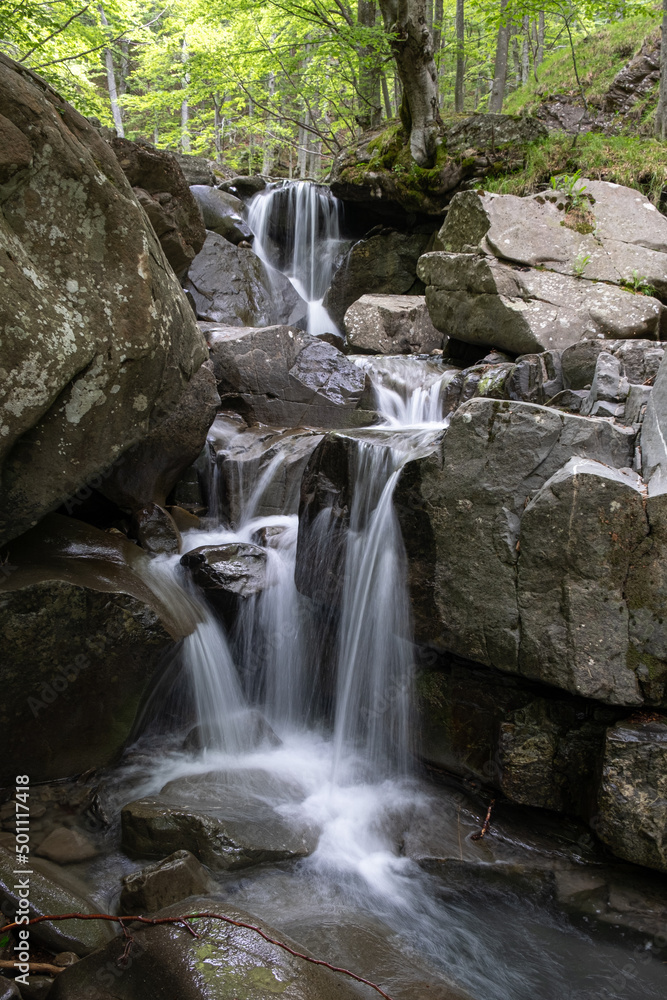 Small waterfall between rocks in the woods, Emilia Romagna Small waterfall between rocks in the woods, Emilia Romagna