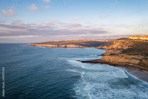 Ericeira drone aerial view on the coast of Portugal with surfers on the sea at sunset, Lisbon area, Portugal photo
