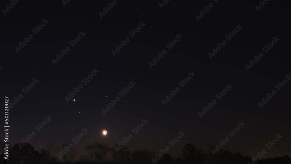 Moon rising on night sky above landscape, time lapse Moon rising on night sky above landscape, time lapse